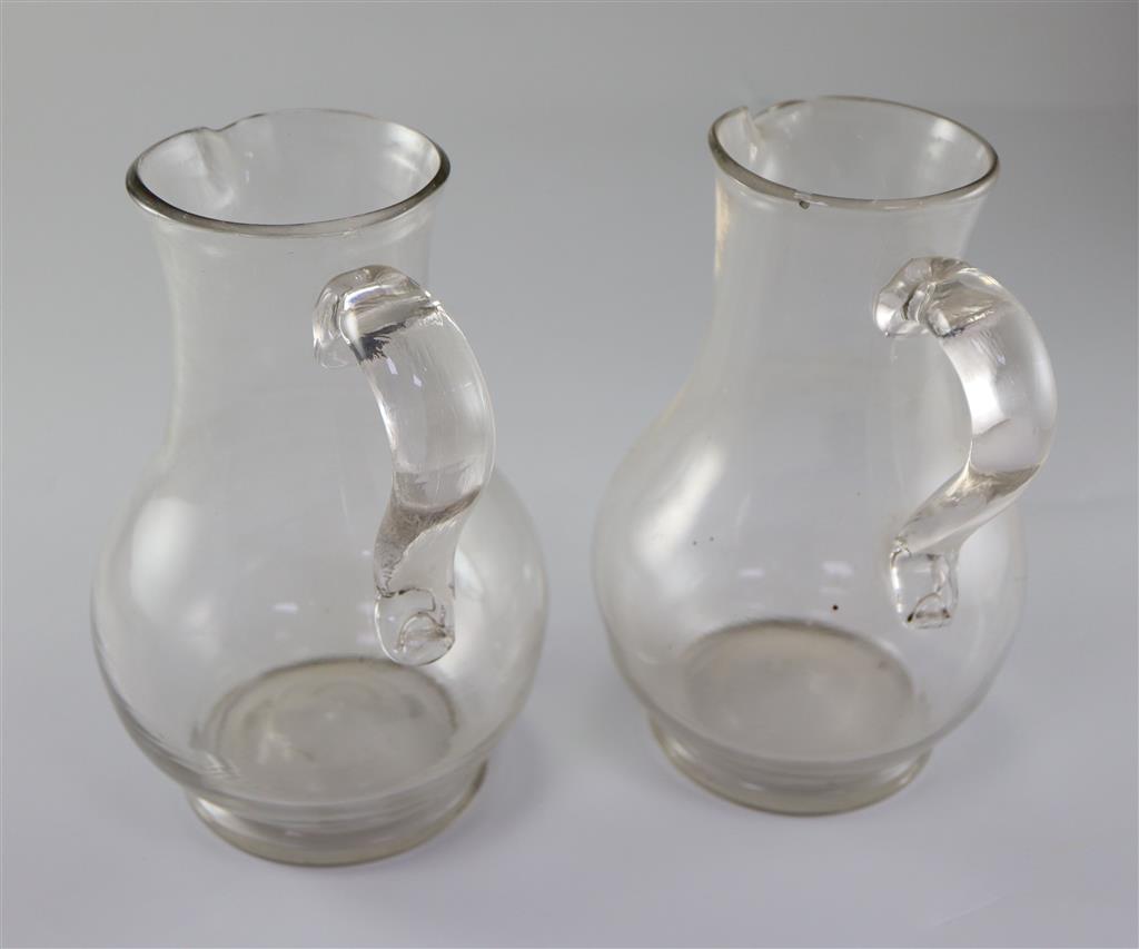 A pair of Georgian glass plain baluster jugs, first half 18th century,